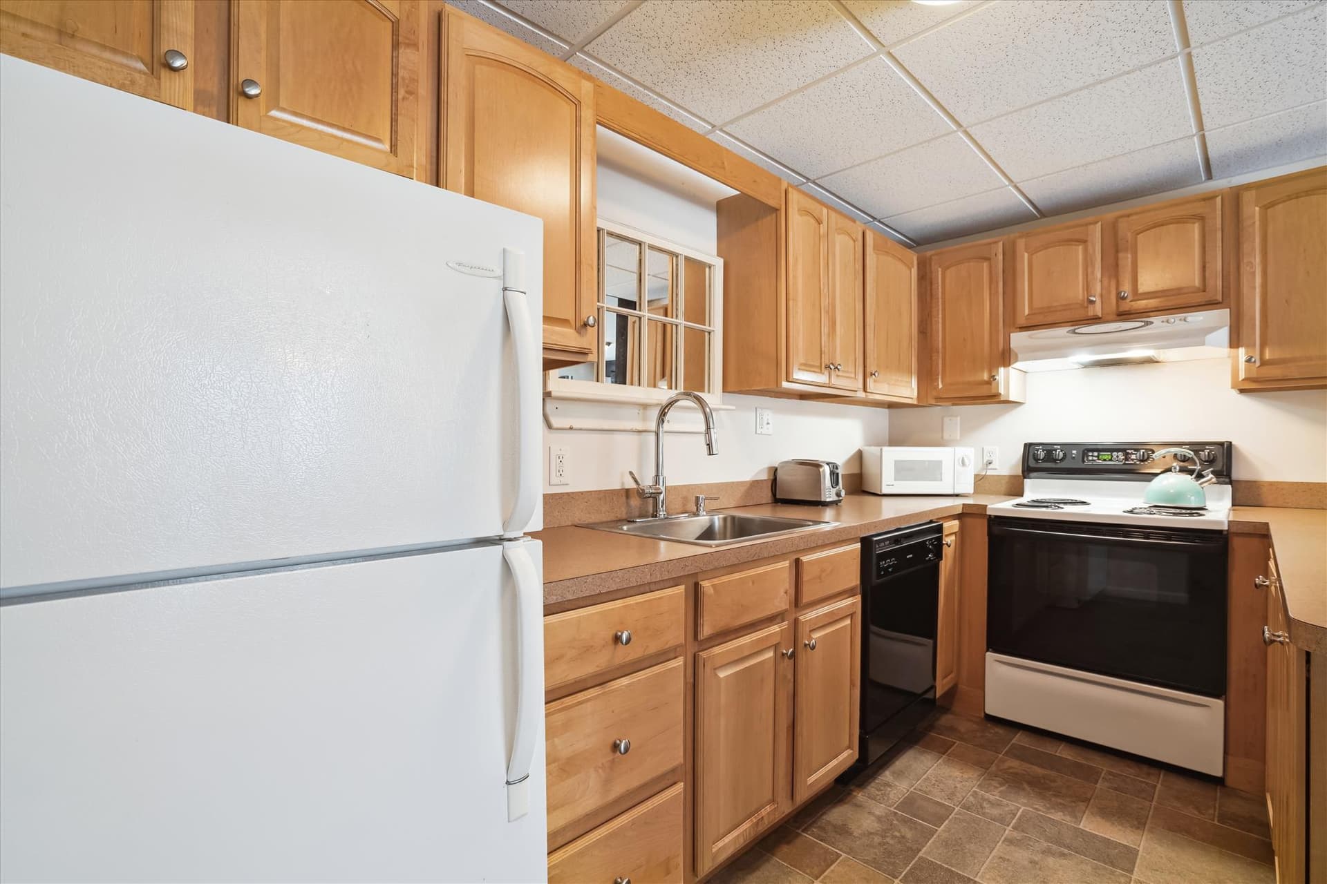 Beautiful bright kitchen with electrical appliances.