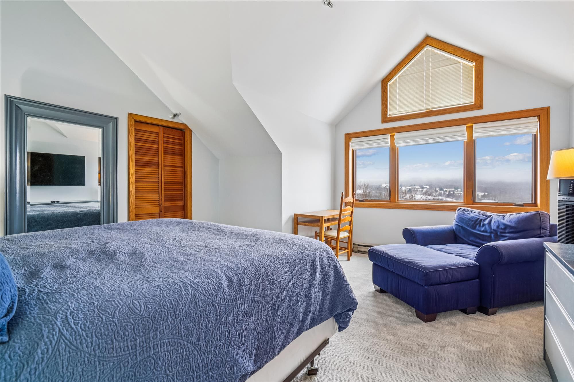 Large upstairs bedroom with a king bed, comfortable seating area, and beautiful mountain views.