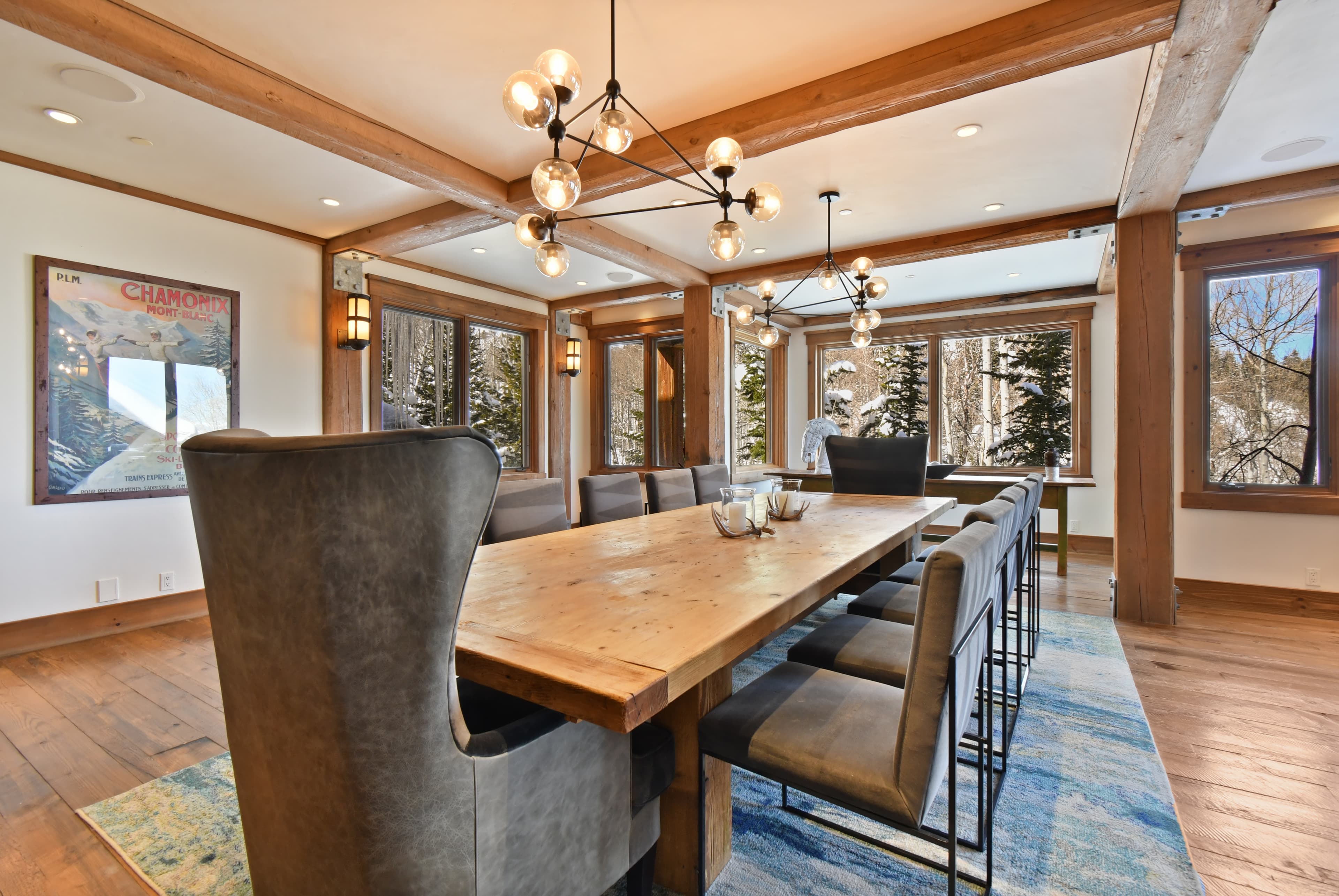 A long wooden table centers the meeting room, surrounded by cushioned chairs and large windows.