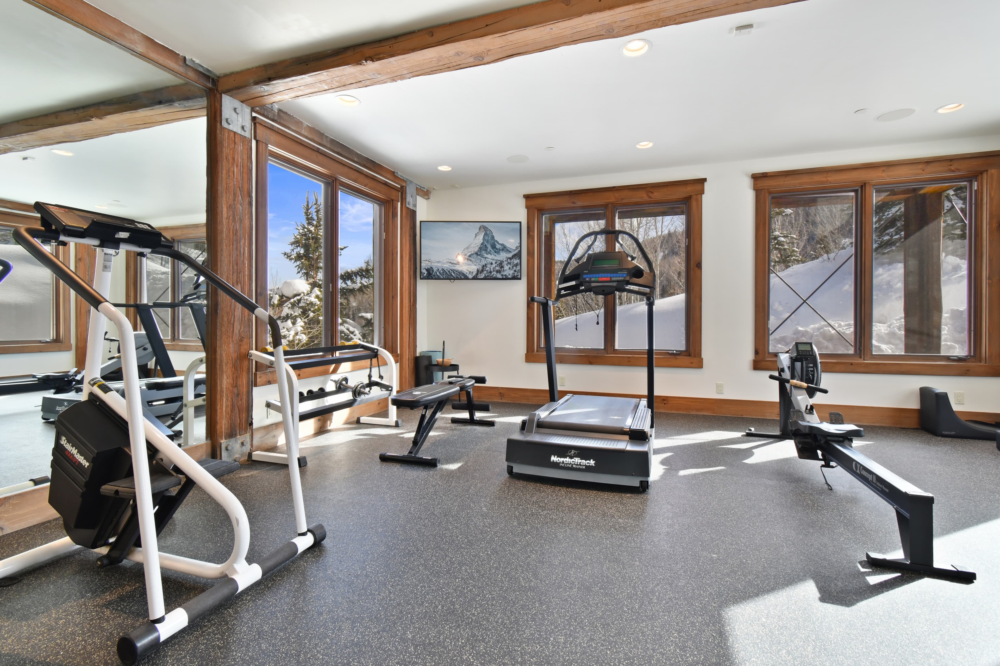 The personal gym equipment of Talus Ridge, complete with a treadmill, benches, and an elliptical.