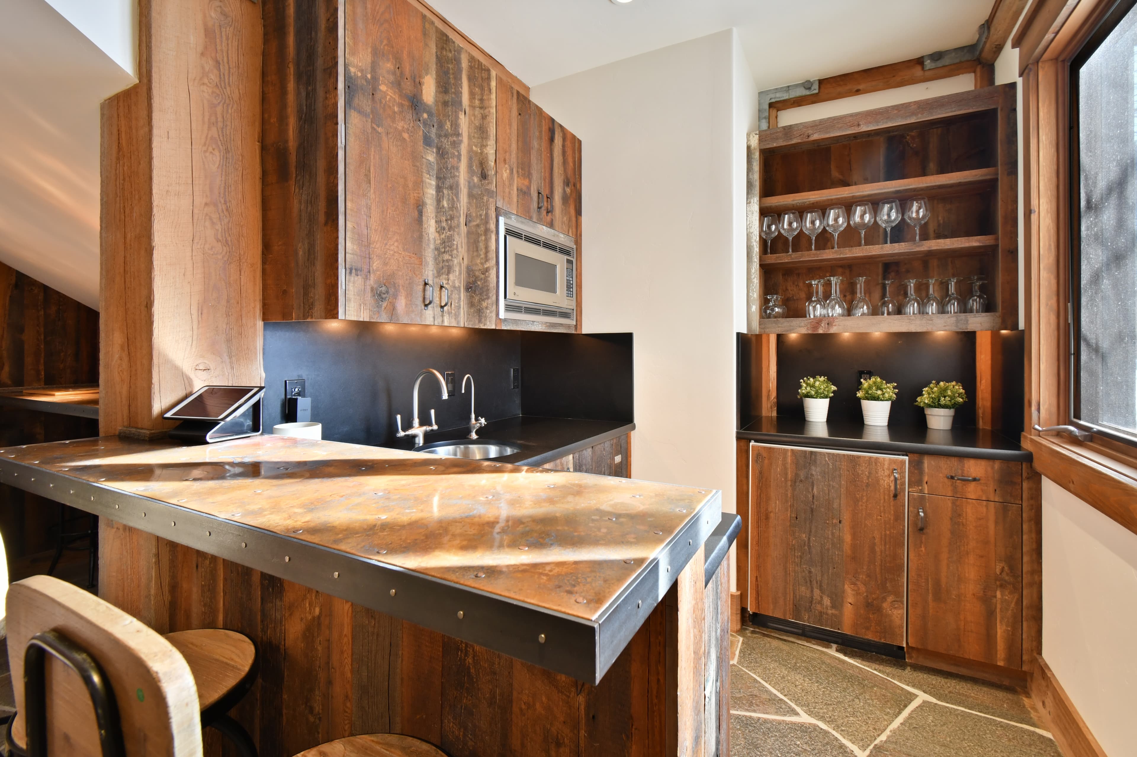 A private kitchen with bar seating, a sink, and a wet bar.