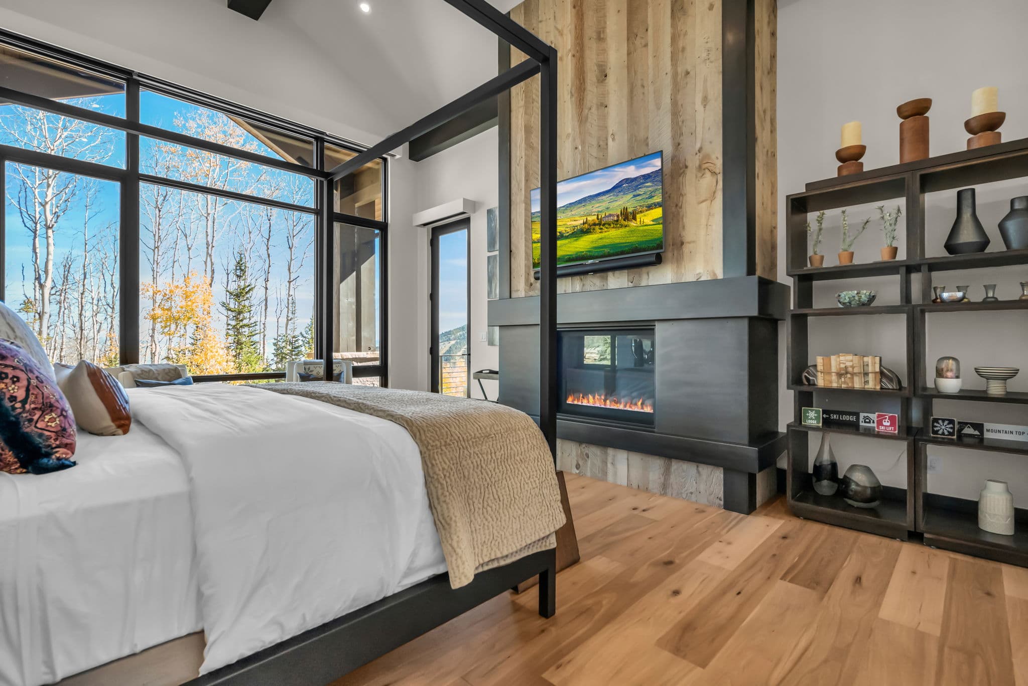 Bedroom with Four-Poster Bed, TV, and Fireplace